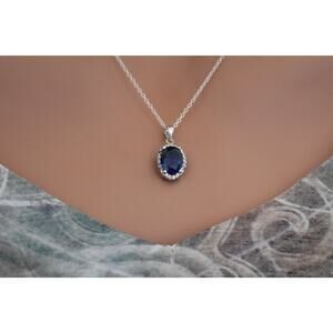 Sterling Silver Blue Oval CZ Pendant Circled in Clear CZ Stones Necklace